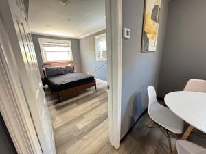a small room with a bed and a table at Cozy Modern 2-Bedrooms Apartment DC in Washington, D.C.