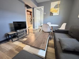a living room with a couch and a table at Cozy Modern 2-Bedrooms Apartment DC in Washington, D.C.