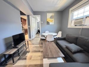 a living room with a couch and a table at Cozy Modern 2-Bedrooms Apartment DC in Washington, D.C.