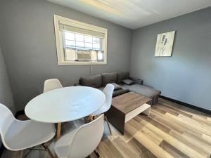 a living room with a white table and a couch at Cozy Modern 2-Bedrooms Apartment DC in Washington, D.C.