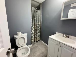 a bathroom with a toilet and a sink at Cozy Modern 2-Bedrooms Apartment DC in Washington, D.C.