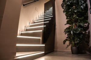 a stairway with a light shining through a door at Corsaro Etna Palace in Motta SantʼAnastasia +33 photos
