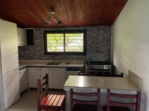 a kitchen with a table and chairs and a window at Guanawanna in Loreto