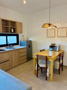 a kitchen with a wooden table with a microwave on it at Plaza Suites Cafayate in Cafayate