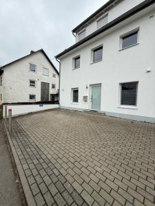 an empty parking lot in front of two buildings at Team at Home Senden in Senden