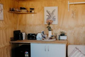 a kitchen with a counter with appliances on it at Warm & Cosy Studio Cabin in Hamilton
