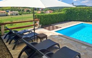 a group of chairs and an umbrella next to a swimming pool at Lukas-Gologorica in Gologorica +29 photos