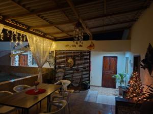 a dining room with a table and chairs and a christmas tree at Anthony in Salinópolis