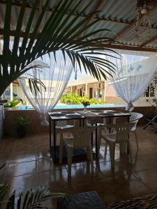 a patio with tables and chairs and a pool at Anthony in Salinópolis