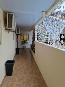 a hallway with a wall filled with lots of vases at Anthony in Salinópolis