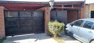 a car parked in front of two black garage doors at Cata, Casa de Descanso in Salta