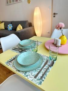 a table with plates and glasses on top of it at Sitka1 apartment in Trenčín +18 photos