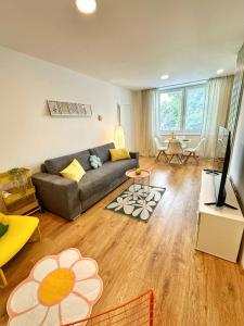 a living room with a couch and a television at Sitka1 apartment in Trenčín