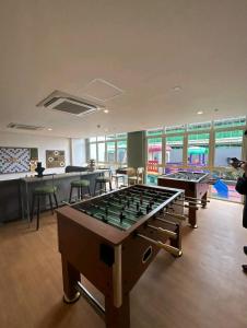 a room with a pool table and several tables at Sweet Escape Executive Studio at One Regis in Bacolod