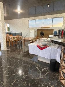 a dining room with a white table and chairs at Caribe de Alter - Hotel & Pousada in Santarém