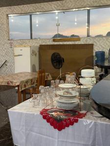 a table with plates and glasses on top of it at Caribe de Alter - Hotel & Pousada in Santarém