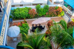an aerial view of a patio with tables and an umbrella at ASVA BEACH Resort in Grand-Popo