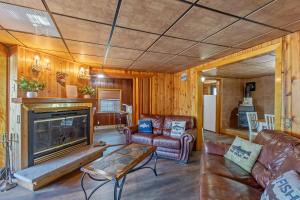 a living room with a couch and a fireplace at Riverside Cabin with Private Fishing Access! in Pulaski
