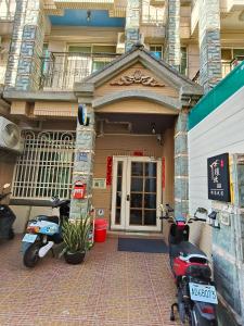 two scooters parked in front of a building at Kinmen Huan Bei 88 B&B in Jincheng