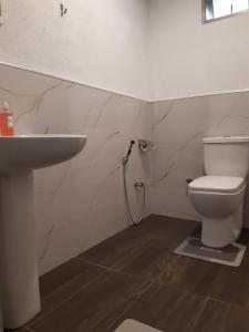 a bathroom with a toilet and a sink at Cloud Trails Hostel Ella in Ella +29 photos