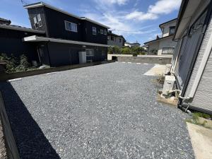 a parking lot in front of a house at 灯ゲストハウス石巻 in Ishinomaki