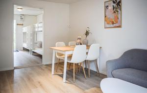 a dining room with a table and white chairs at Beautiful Home In Ystad in Ystad