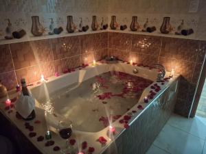 a bath tub filled with candles and flowers in a bathroom at Balneario del Inca in Los Baños del Inca