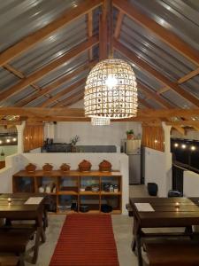 a room with tables and a chandelier in a building at Cloud Trails Hostel Ella in Ella