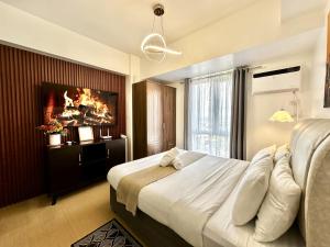 a bedroom with a large bed and a fireplace at City View Studio Unit at Centrio Tower beside Ayala Mall in Cagayan de Oro +26 photos