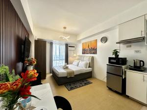 a small room with a bed and a kitchen at City View Studio Unit at Centrio Tower beside Ayala Mall in Cagayan de Oro