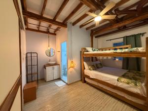 a bedroom with two bunk beds and a ceiling fan at Hotel Stay Mar Baru in Cartagena de Indias