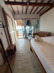 a bedroom with a bed and a couch in a room at Hotel Stay Mar Baru in Cartagena de Indias