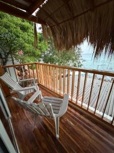 two chairs sitting on a deck with the ocean at Hotel Stay Mar Baru in Cartagena de Indias