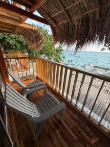 a porch with two lounge chairs on the beach at Hotel Stay Mar Baru in Cartagena de Indias
