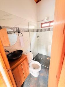 a small bathroom with a toilet and a shower at Cabaña Alto Verde in Chiquinquirá +48 photos