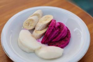 a white plate with bananas and red food on it at Gati Cottage in Nusa Penida +90 photos