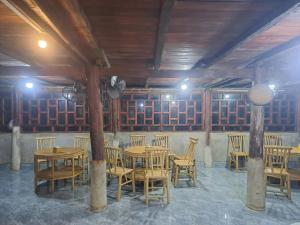 a dining room with wooden tables and chairs at Kim in Cao Bằng