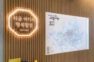 a sign hanging on a wall with a map at Stay5 Jongno in Seoul