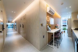 a hallway of a kitchen with a counter and chairs at Stay5 Jongno in Seoul