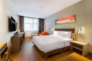 a hotel room with a large bed and a desk at Holiday Inn Express Changbaishan by IHG in Fusong +86 photos