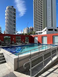 a swimming pool on the roof of a building with skyscrapers at Broadbeach on the Park in Gold Coast