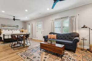 a living room with a couch and a table at Loft Haven - Rooftop Terrace in Charlotte +15 photos