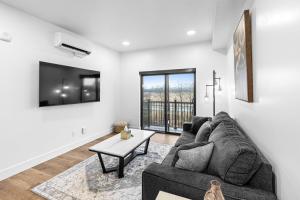 a living room with a couch and a table at Airport Access with Stunning View A103 in Juneau