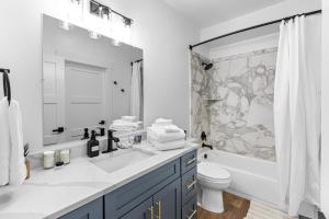 a bathroom with a sink and a toilet and a shower at Airport Access with Stunning View A103 in Juneau +54 photos