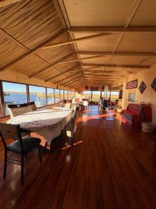 a large room with a bed and chairs in it at Titicaca Samca Lodge Puno Peru in Puno