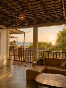 a living room with a couch and a view of the ocean at ECOHOTEL LILI in Puerto Limón