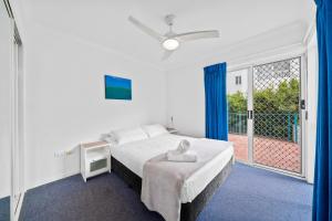 a bedroom with a large bed and a balcony at Paradise Isles in Gold Coast