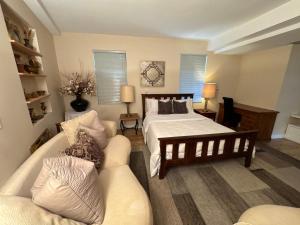 a living room with a bed and a couch at Dream House -Water Lily in Horseshoe Bay