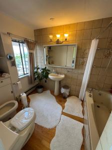 a bathroom with a sink and a tub and a toilet at Dream House -Water Lily in Horseshoe Bay +188 photos