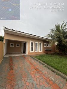 a house with a brick driveway in front of it at Casa com piscina 20 Leitos in Cuiabá